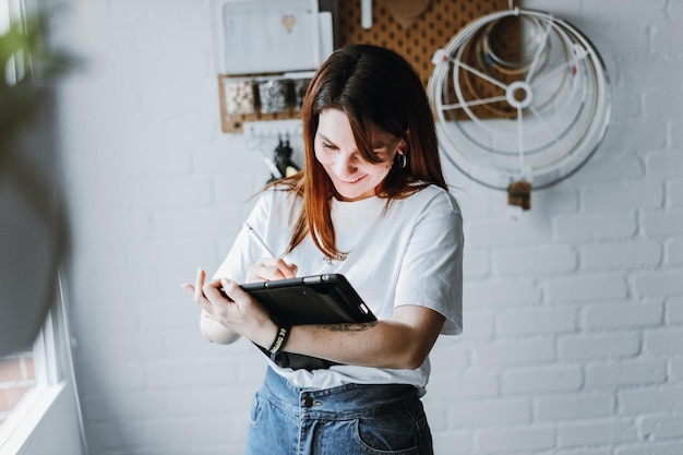 Young girl drawing on tablet indoors