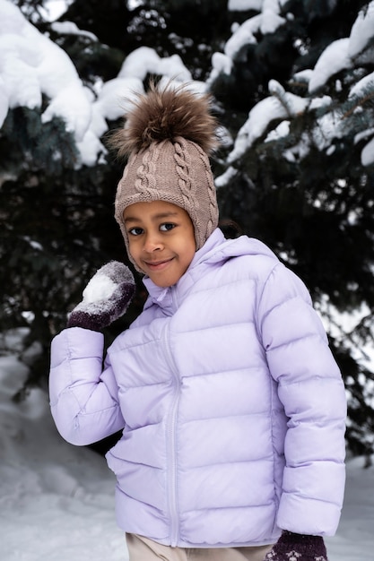 Free photo young girl enjoying a winter day outdoors