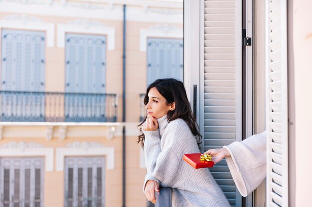 Young girl getting present from partner