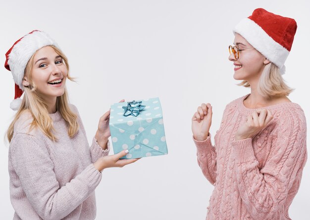 Young girl giving her friend a gift