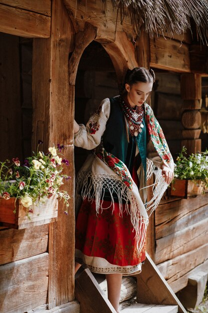 Young girl goes out of the house in a traditional Ukrainian dress