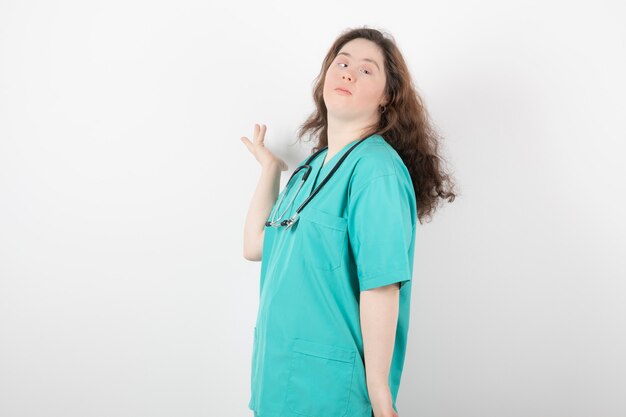 young girl in green uniform standing and posing .