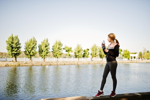 Young girl has the training and doing exercise outdoors Sport fitness street workout concept