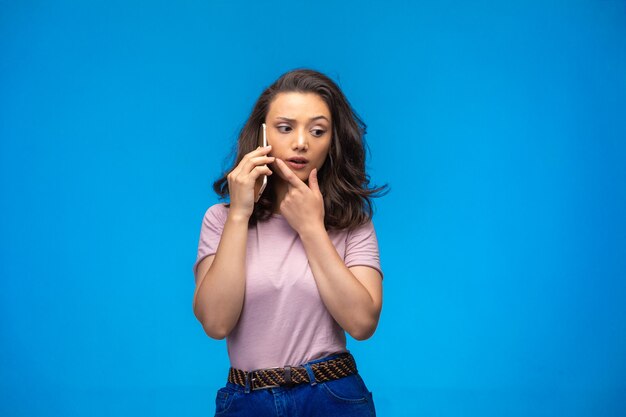 Young girl having call at her smartphone.