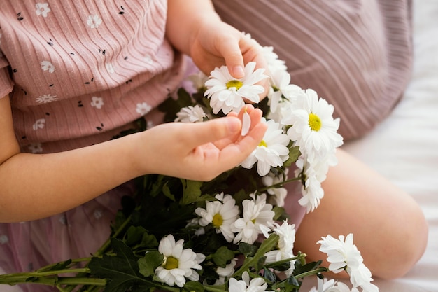 Young girl holding bouquet of spring flowers