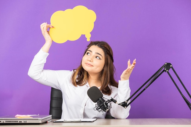 Young girl holding paper speech bubble and stretching her hair High quality photo