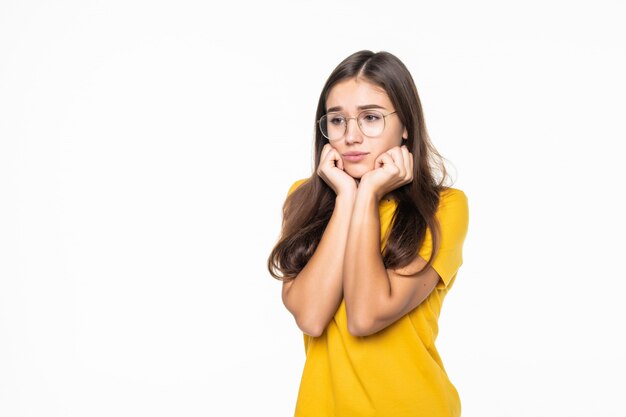 Young girl is bored, dressed in black, isolated on white wall