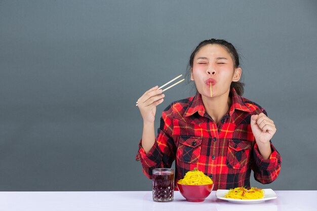 Young girl is enjoy eatting spaghetti at home