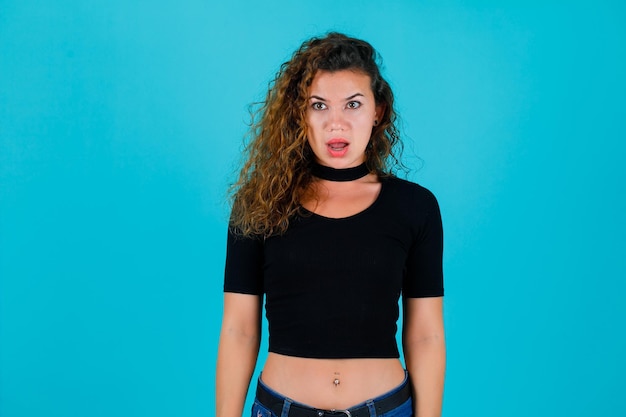 Young girl is looking away on blue background