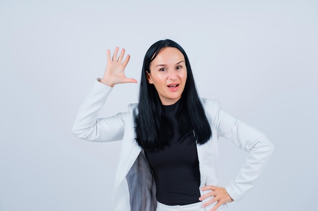 Young girl is showing five gesture by raising up her handful on white background