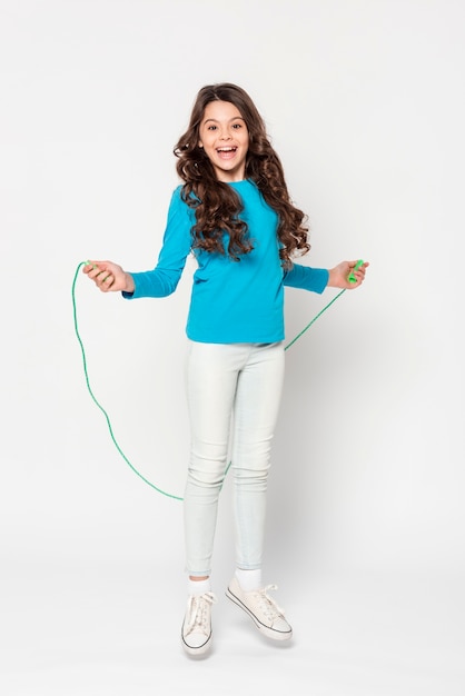 Free photo young girl jumping rope