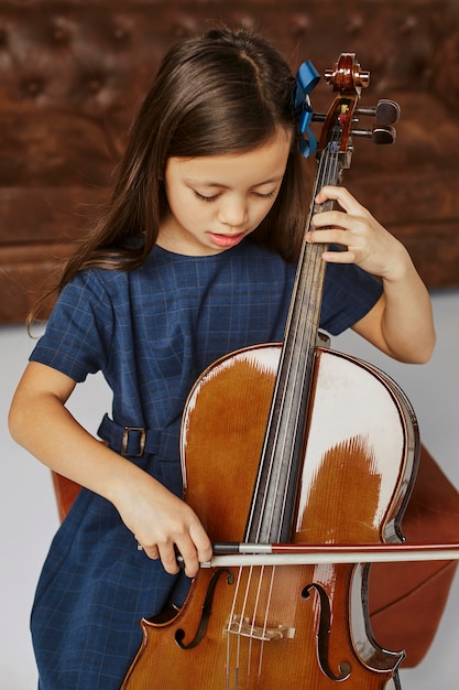 Young girl learning how to play the cello