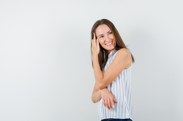 Young girl looking away in t-shirt, jeans and looking optimistic .