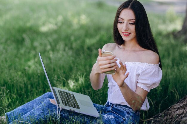 Young girl looking at her smart phone while smiling