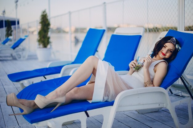 Young girl lying on a blue hammock