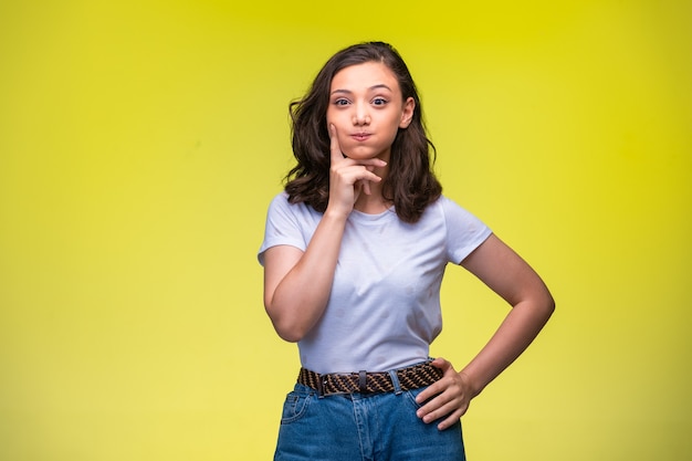 Young girl makes doubtful face. 