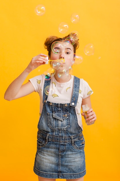 Young girl making bubbles