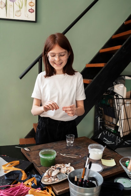 Young girl making diy crafts in upcycle project