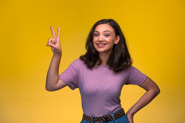 Young girl making friendship sign in hand. 