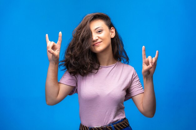 Young girl making peace symbol with fingers and enjoying the moment