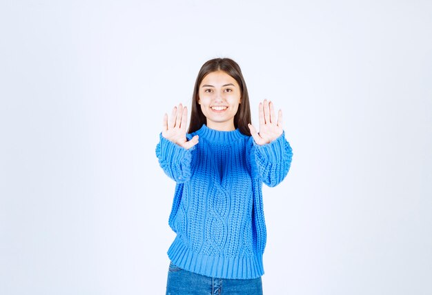 young girl model showing stop sign .