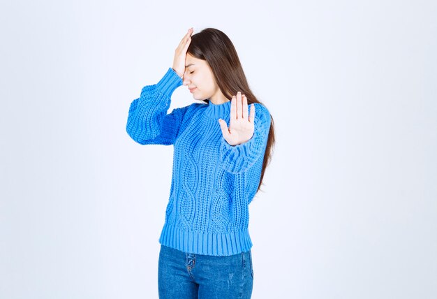 young girl model showing stop sign .