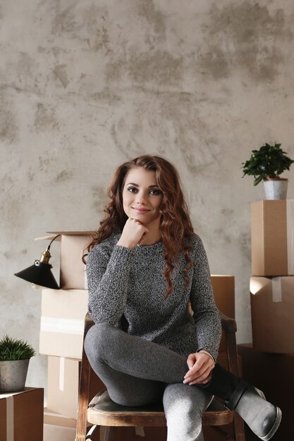 Young girl packing things to move to a new apartment