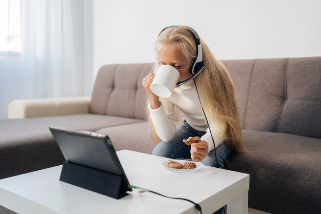 young girl paying attention to online class