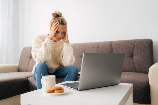 Young girl paying attention to online class