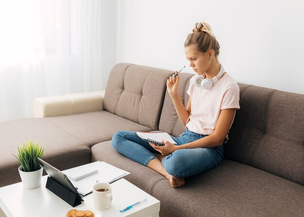 Young girl paying attention to online class