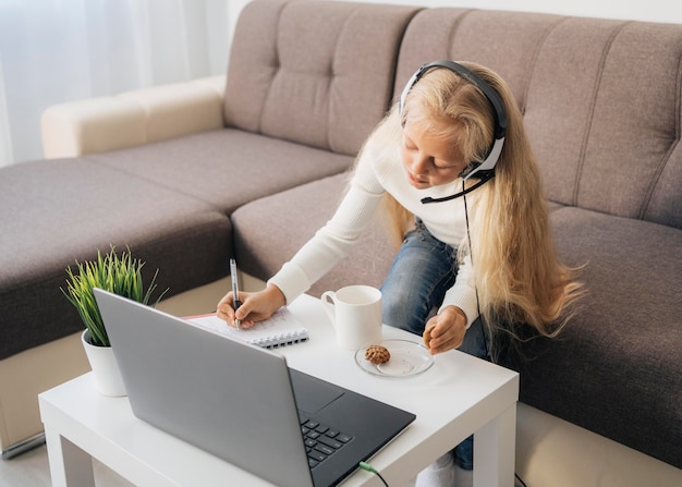 Young girl paying attention to online class