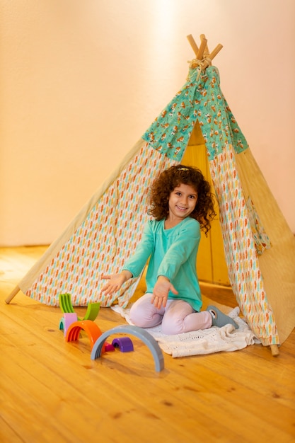 Free photo young girl playing indoors with eco toys