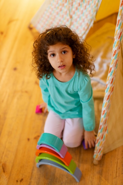 Free photo young girl playing indoors with eco toys