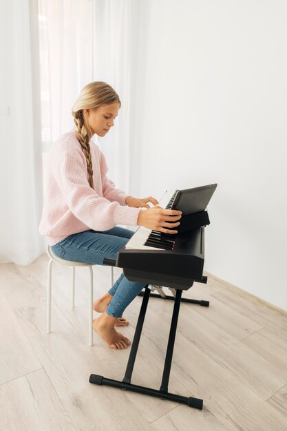 Young girl playing keyboard instrument