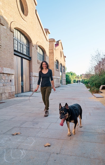 Free photo young girl playing with her dog, concept. dog and human friendship