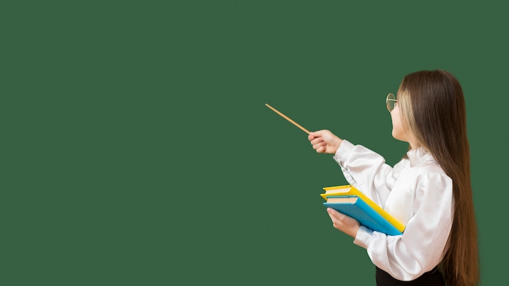 Free Photo young girl pointing at blackboard