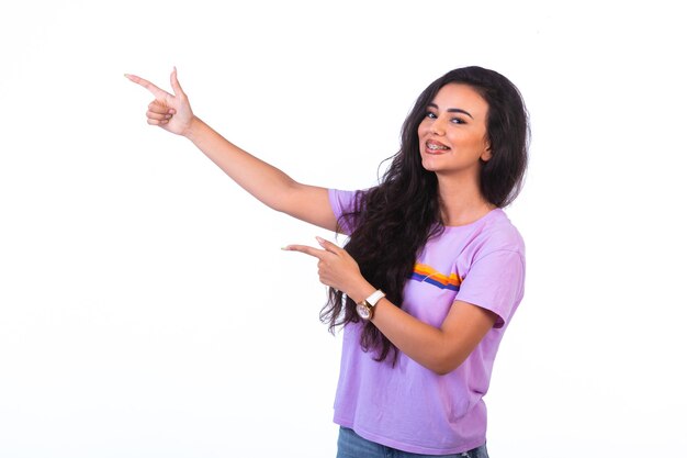 Young girl pointing at something and making presentation. 