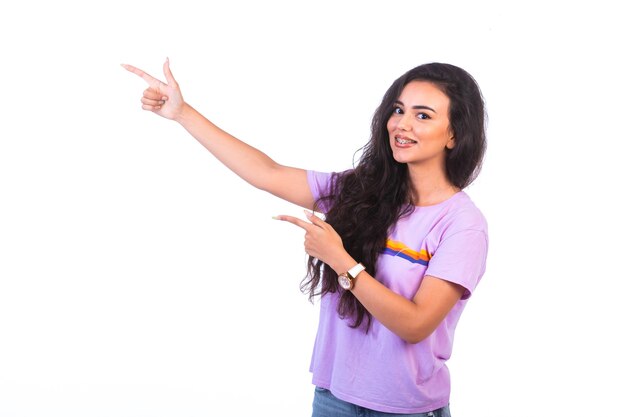 Young girl pointing at something and making presentation. 