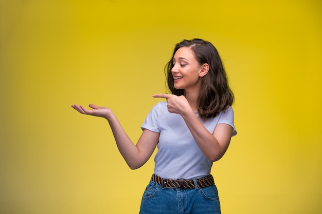 Young girl pointing to something with finger and looking to that side. 