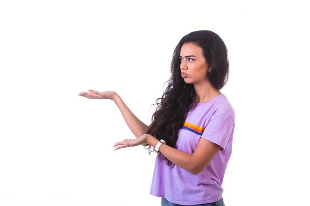 Young girl presenting something left. 