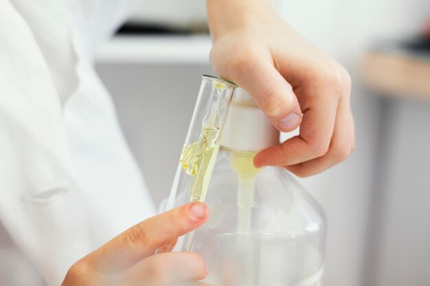 Young girl scientist filling test tube