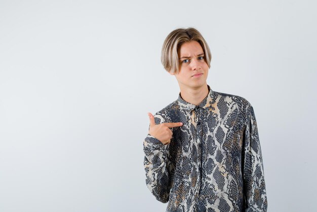 Young girl showing herself with her finger on white background