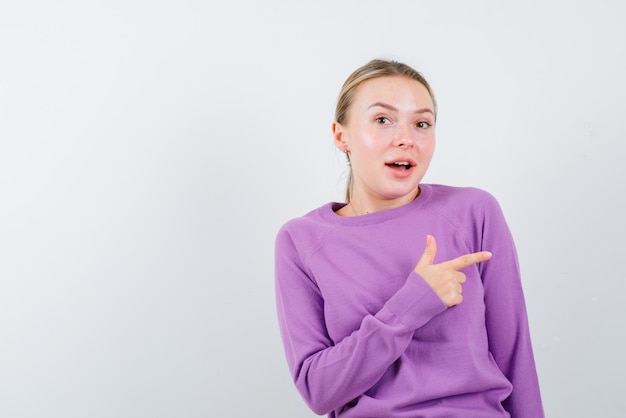 Young girl showing the right with fingers on white background