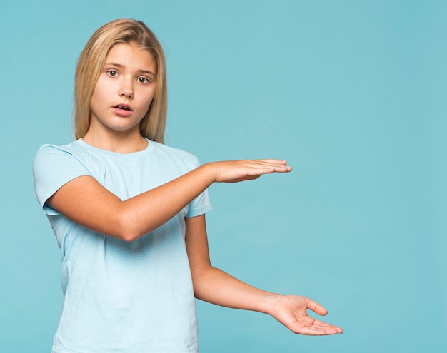 Young girl showing size with hands