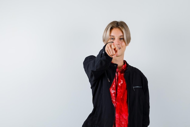 Young girl showing something with her finger on white background