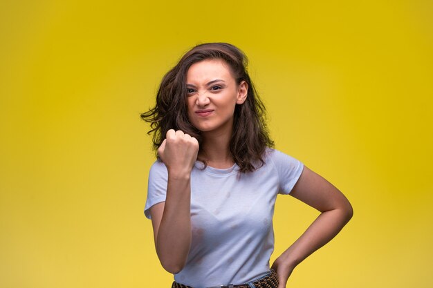 Young girl shows her muscles and shows confidence.