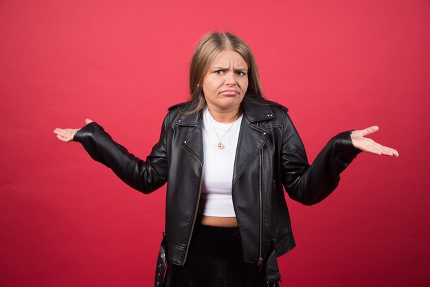 Young girl shrugging her arms and making gesture of I don't know