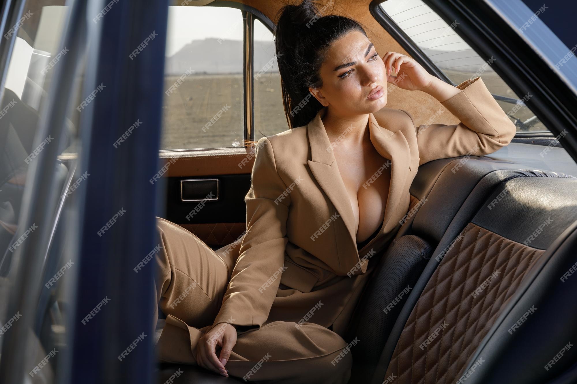 Premium Photo  Serious schoolgirl looking aside while sitting in car