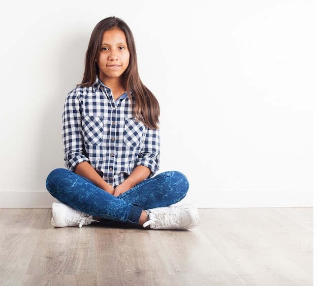 Young girl sitting on the floor