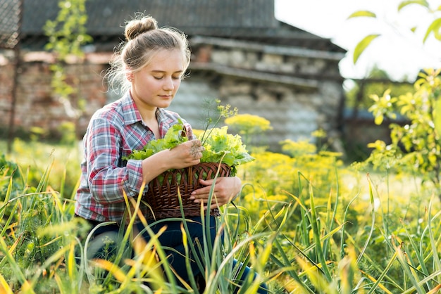 Young girl sitting in grass side view